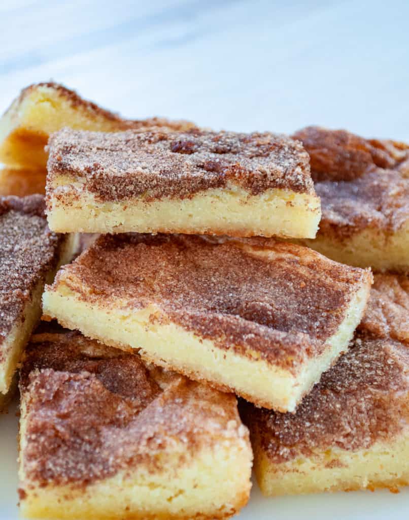 Three snickerdoodle bars on top of a pile of cookies. 