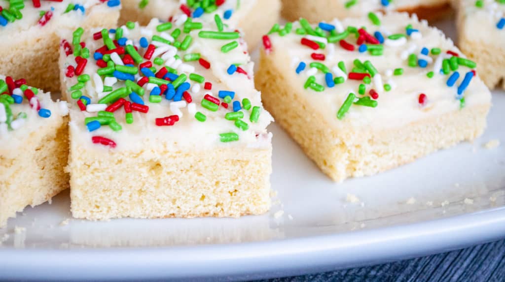 Close-up photo of sugar cookie bars topped with sprinkles.