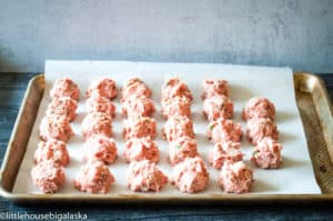 Turkey meatballs arranged on a baking sheet.