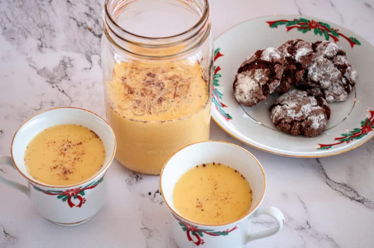 Homemade cooked eggnog recipe and fresh cookies.