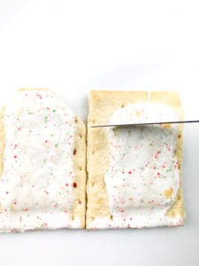 Making walls out of pop-tarts for the no-bake gingerbread house.