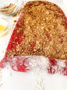 Rolling up cinnamon roll dough.