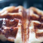 Close-up of a freshly made cinnamon roll waffle.