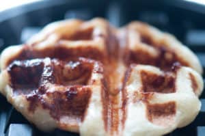 Close-up of a freshly made cinnamon roll waffle.