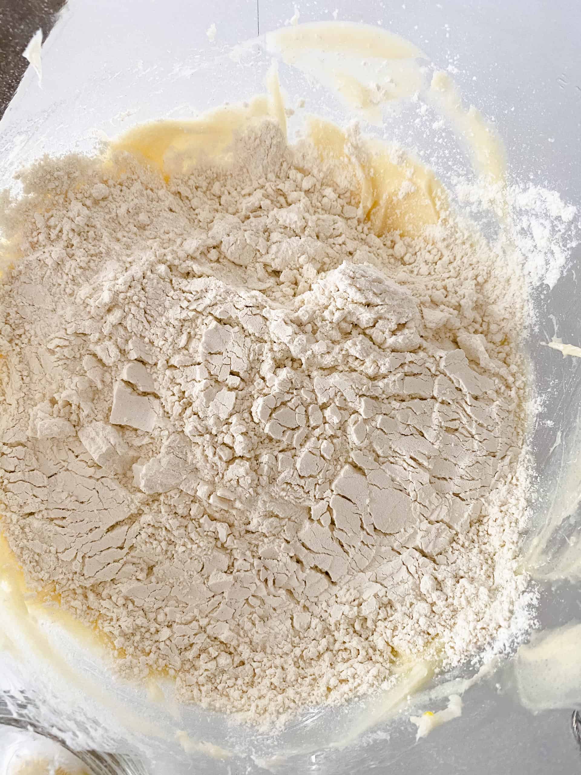 Mixing the flour into the cream cheese mixture.
