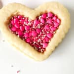 Single filled heart shaped valentine cookie.