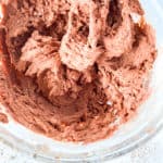 A bowl of red velvet sugar cookie dough mixture.