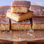 Cake slices stacked on a cutting board.