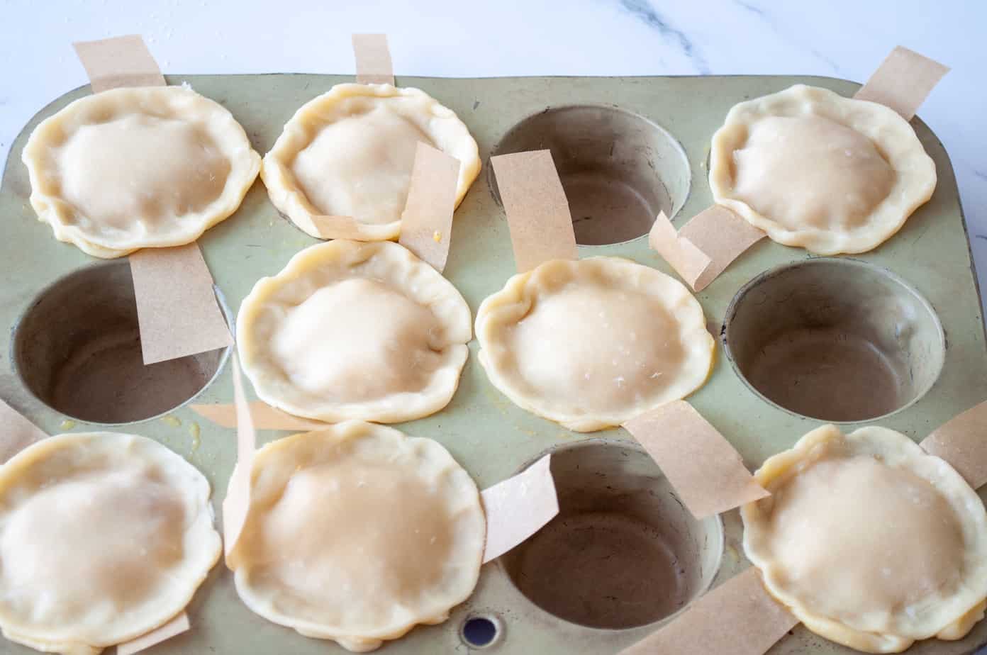 Tiny pies ready for their egg wash.