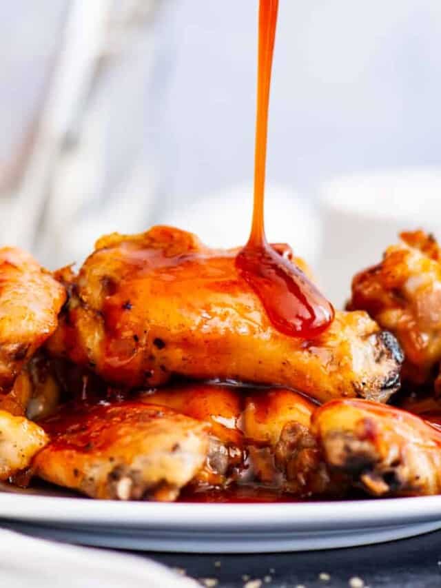 Chicken wings drizzled with sriracha.