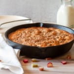 Fresh rhubarb cake with a bottle of milk.