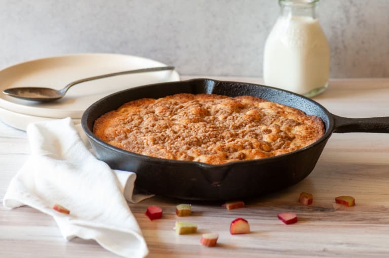 Fresh rhubarb cake with a bottle of milk.
