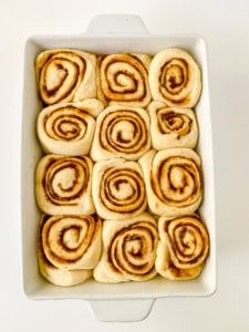 Doubled-in-size gingerbread cinnamon rolls ready to be baked.