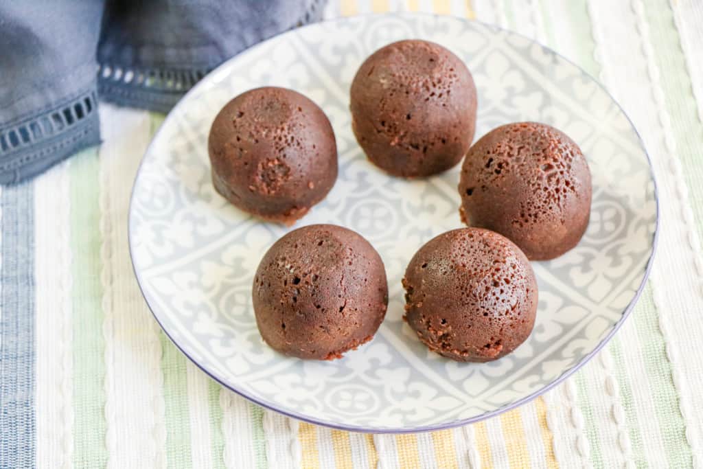 Five Instant Pot Brownie Bites on a round plate.