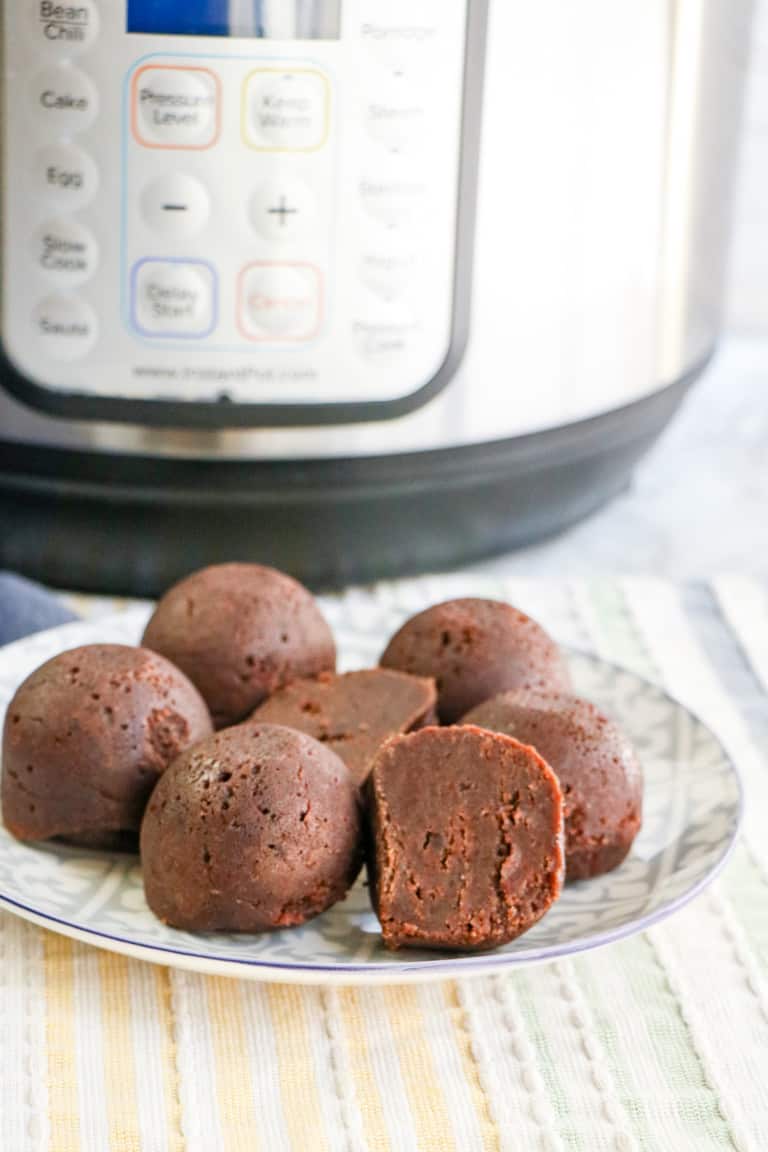 Freshly baked instant pot brownies in a white plate.
