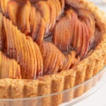 Close-up of an easy glazed apple tart on a stand.