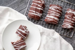 Decadent chocolate mini rolls in a cooling rack.