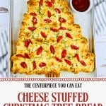 Festive Pull Apart Christmas Tree Bread stuffed with cheese, topped with tomatoes and herbs, served on a baking sheet with white and red dipping sauces.