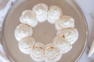Meringue topped with whipped cream.