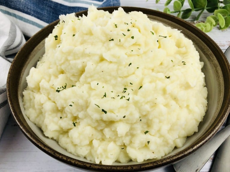 A serving bowl of Instant Pot Mashed Potatoes.