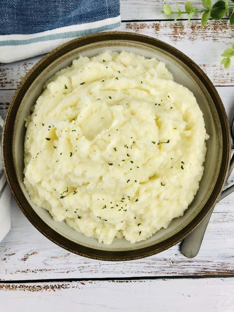 Instant Pot Mashed Potatoes with a parsley garnish.