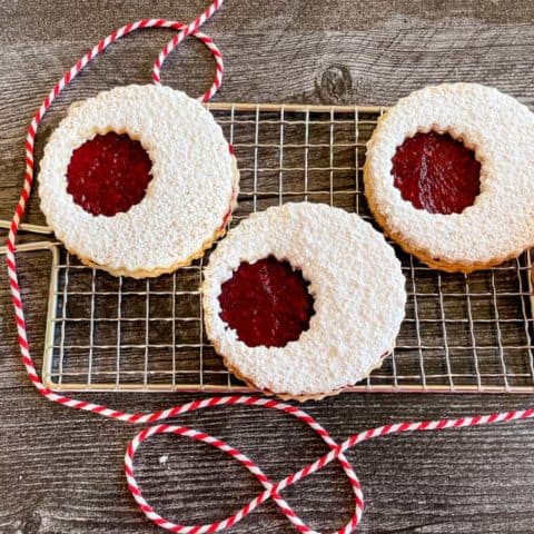 Linzer cookies with twine and cooling rack.