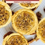 A plate of MINI PECAN PIES with crumbly crusts and pecan filling, surrounded by scattered pecan pieces—these no corn syrup mini pecan pies are a delightful bite-sized treat.
