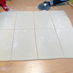 Cutting the vegan sausage rolls into six equal pieces.