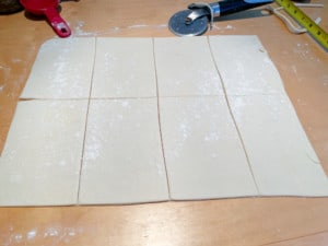 Cutting the vegan sausage rolls into six equal pieces.