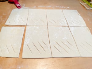 Cut slashes in sausage rolls.