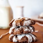 Chocolate crinkle cookies stacked up.