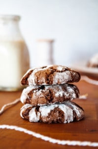Chocolate crinkle cookies stacked up.