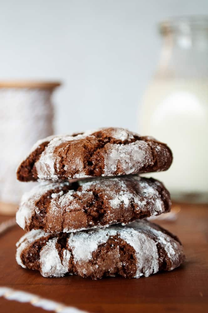 Chocolate crinkle cookies stacked up.