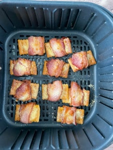 Fully cooked bacon around crackers.