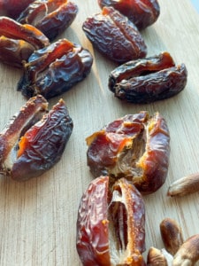 Pitted dates on a wooden surface.
