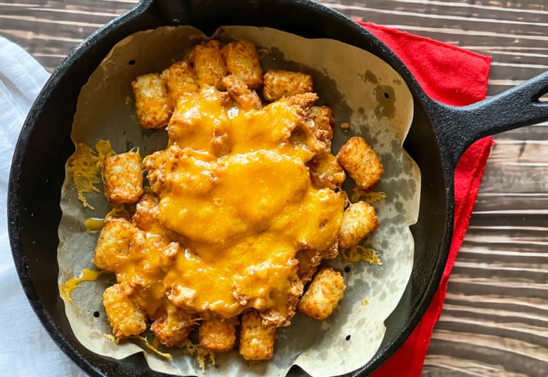 Melted cheese and beans on tater tots.