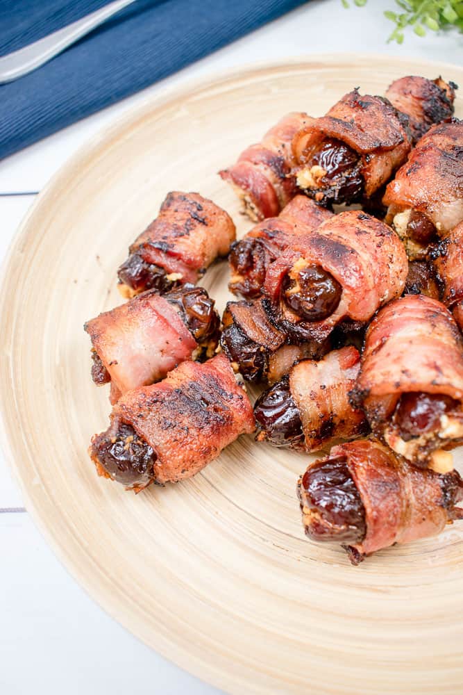 Easy appetizer bacon wrapped dates on a plate to be served.