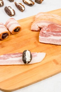 Wrap stuffed dates in bacon.