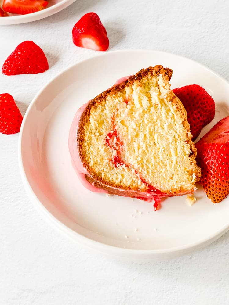 A slice of strawberry served with fresh slices of strawberries.