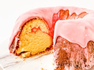 Sliced sweet strawberry pound cake topped with an icing.