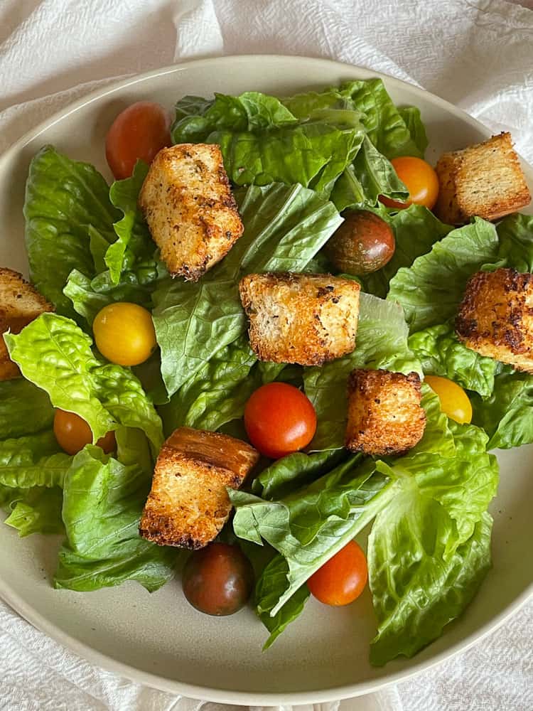 A green salad topped with homemade croutons.