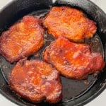 4 Oven BBQ Pork Chops in a cast iron skillet.