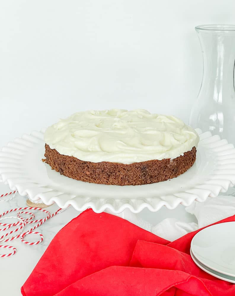 Frosted gingerbread cake on a cake plate.