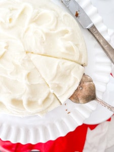 Frosted Gingerbread Cake on a cakeplate with a cake server and knife.