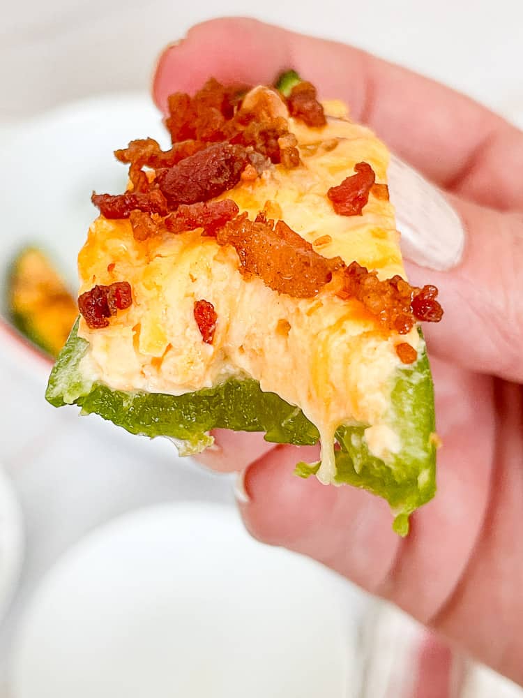 A bacon jalapeño popper with a bite out of it.