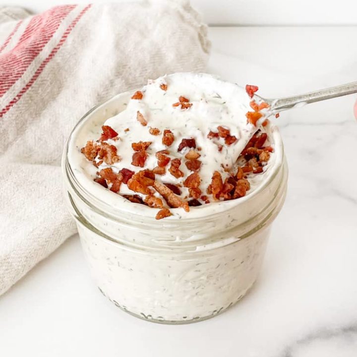 Bacon Ranch Dressing in a jar with a spoon.
