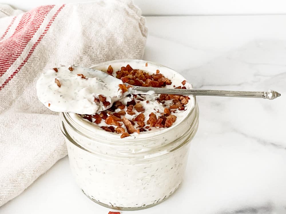 A jar full of bacon ranch dressing.
