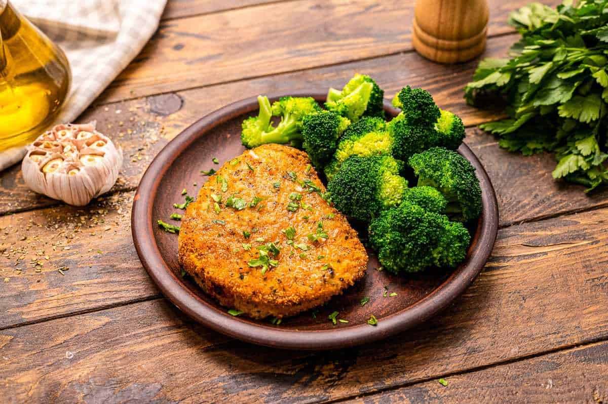 Air-fried pork chop served with broccoli.