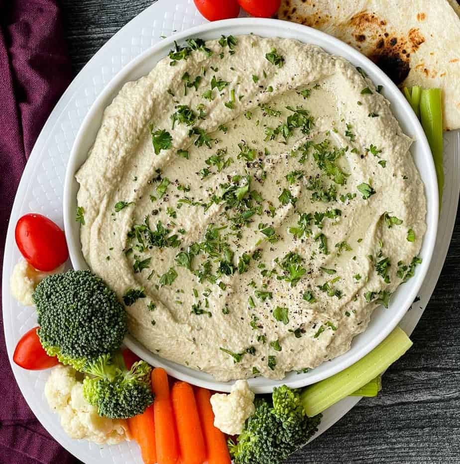 Rosted Eggplant dip surrounded by vegetables. 