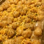 Cheesy tater tot casserole in a baking pan.